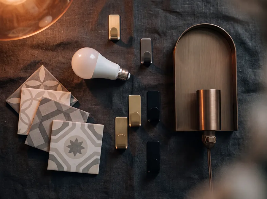 Peel-and-stick tiles, a smart bulb, adhesive hooks and a plug-in sconce on dark linen